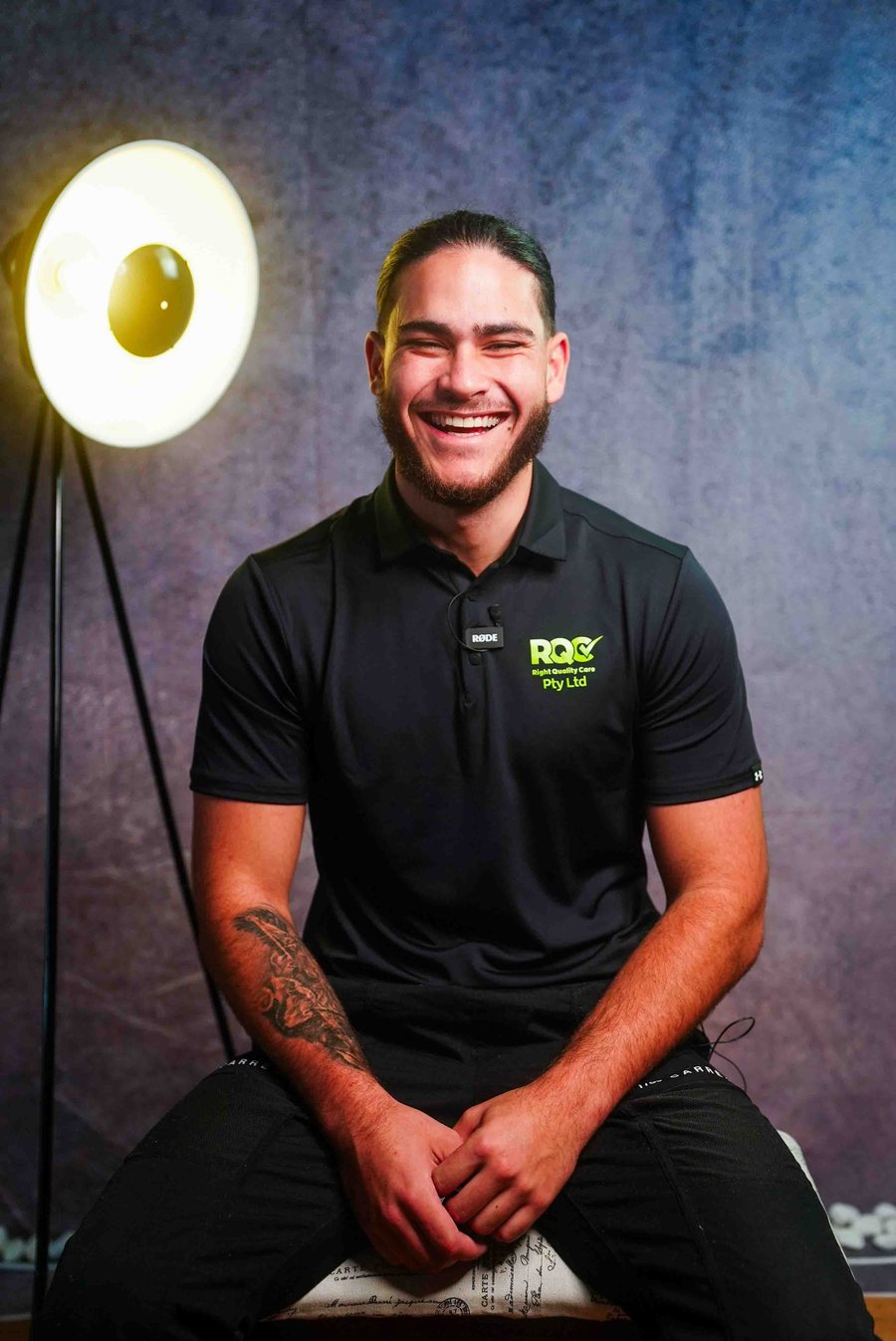 A Right Quality Care support worker in uniform, smiling.